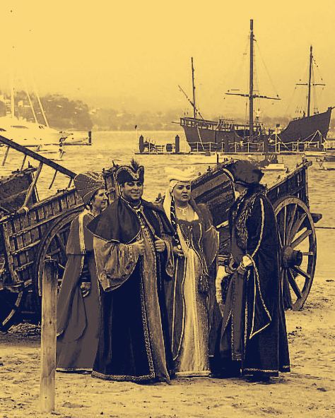 Recreación de la Arribada en la playa de Baiona: personajes con vestuario de época junto a un carro y, al fondo, la réplica de La Pinta.